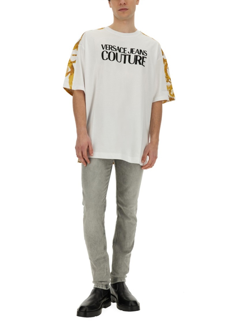 Shop Versace Jeans Couture Oversized T-shirt With Bold Logo And Intricate Patterned Sleeves In White