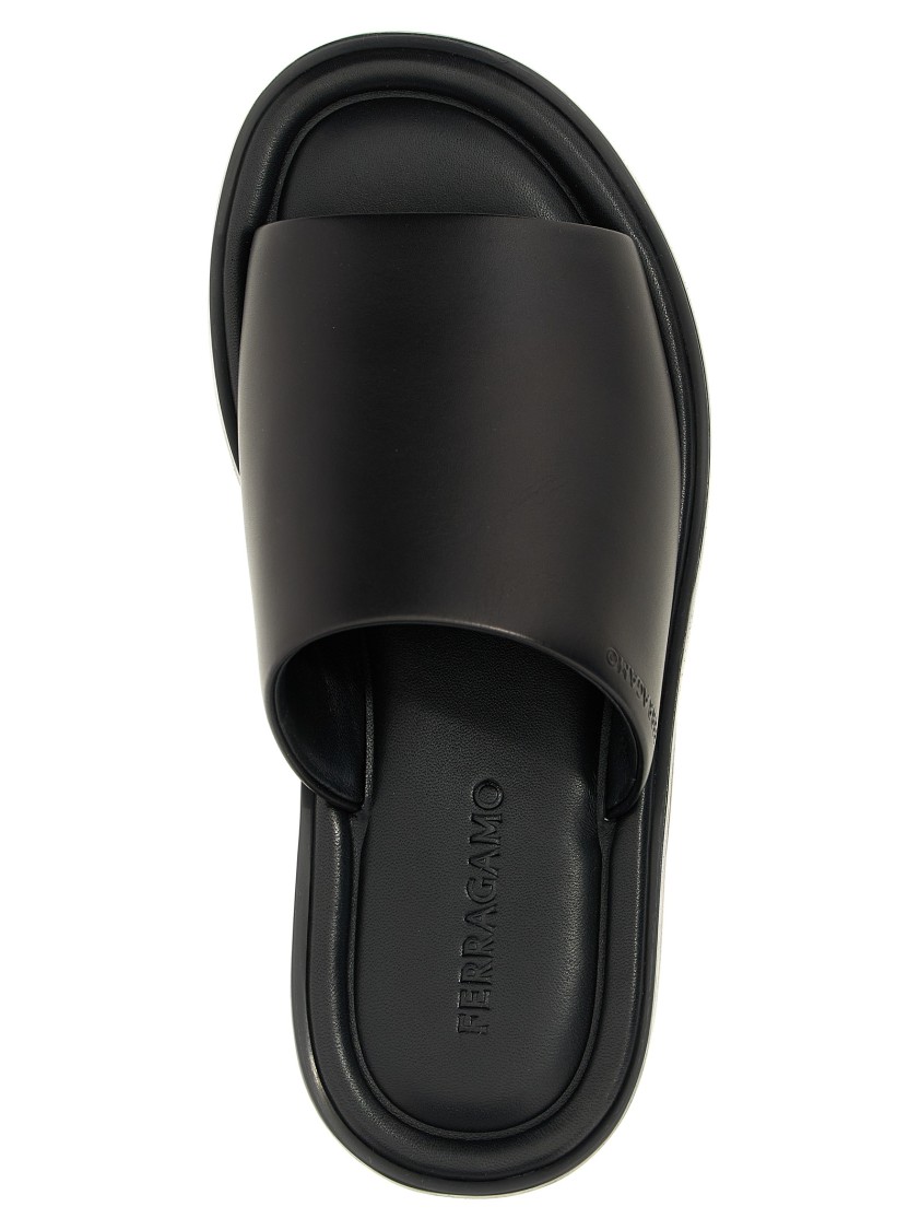 Ferragamo Logo Embossed Leather Slides In Black