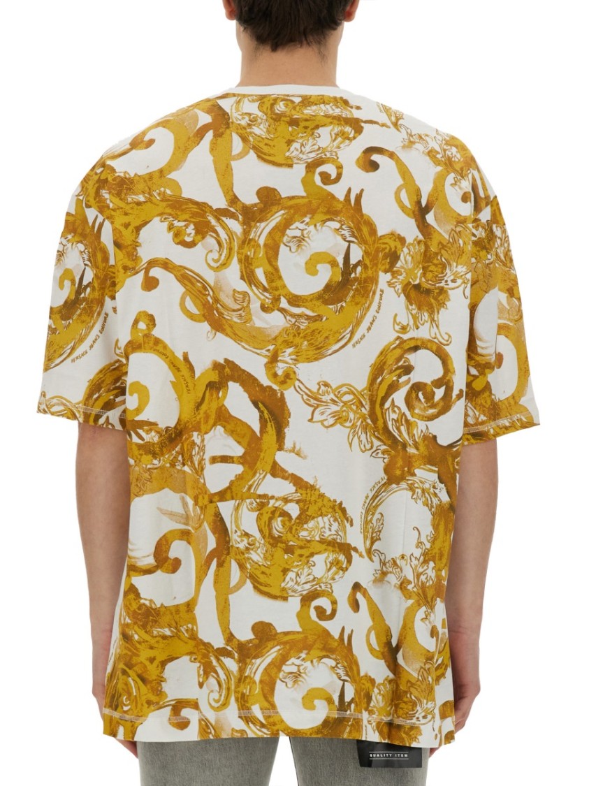 Shop Versace Jeans Couture Oversized T-shirt With Bold Logo And Intricate Patterned Sleeves In White