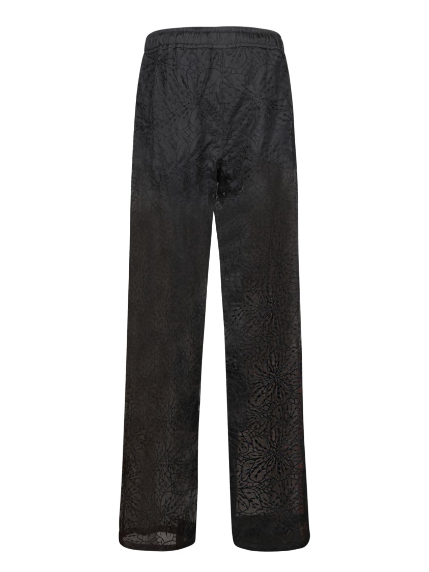 GENNY GENNY HIGH-WAISTED BLACK SILK TROUSERS WITH FLORAL DESIGN 