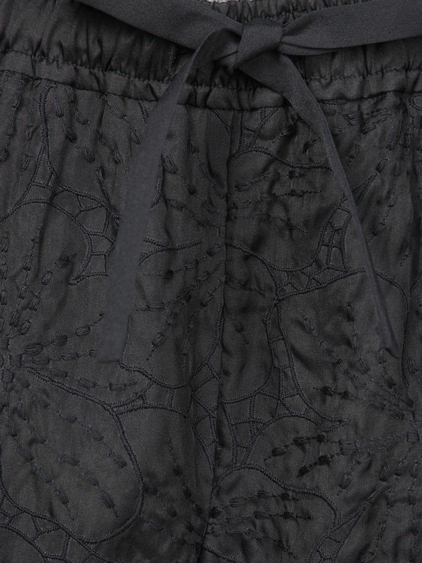 GENNY GENNY HIGH-WAISTED BLACK SILK TROUSERS WITH FLORAL DESIGN 